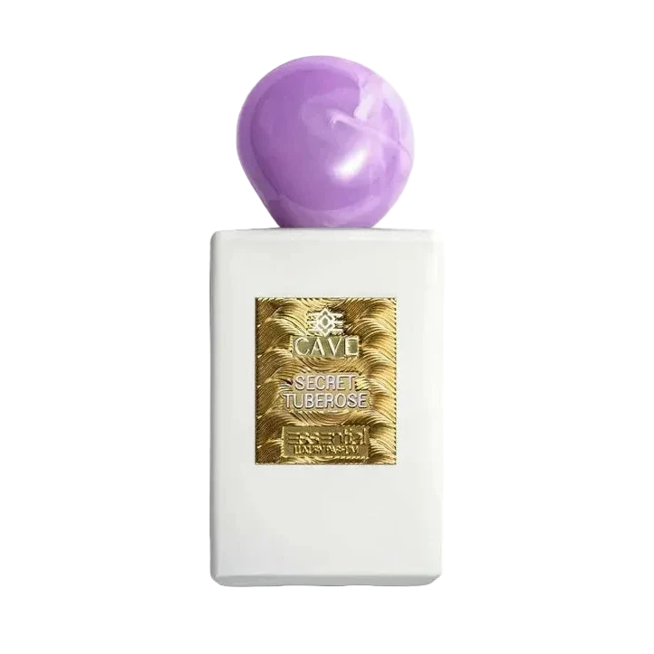 A white perfume bottle with a gold label and a purple cap, the product 'Cave Secret Tuberose'.