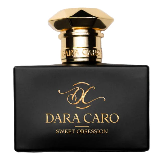 A black perfume bottle with gold details, labeled 'DARA CARO SWEET OBSESSION', with a golden cap.