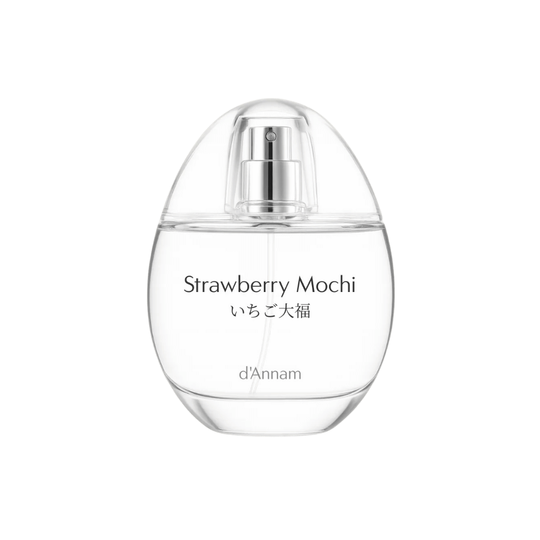 Clear perfume bottle labeled 'Strawberry Mochi' by d'Annam on a green background