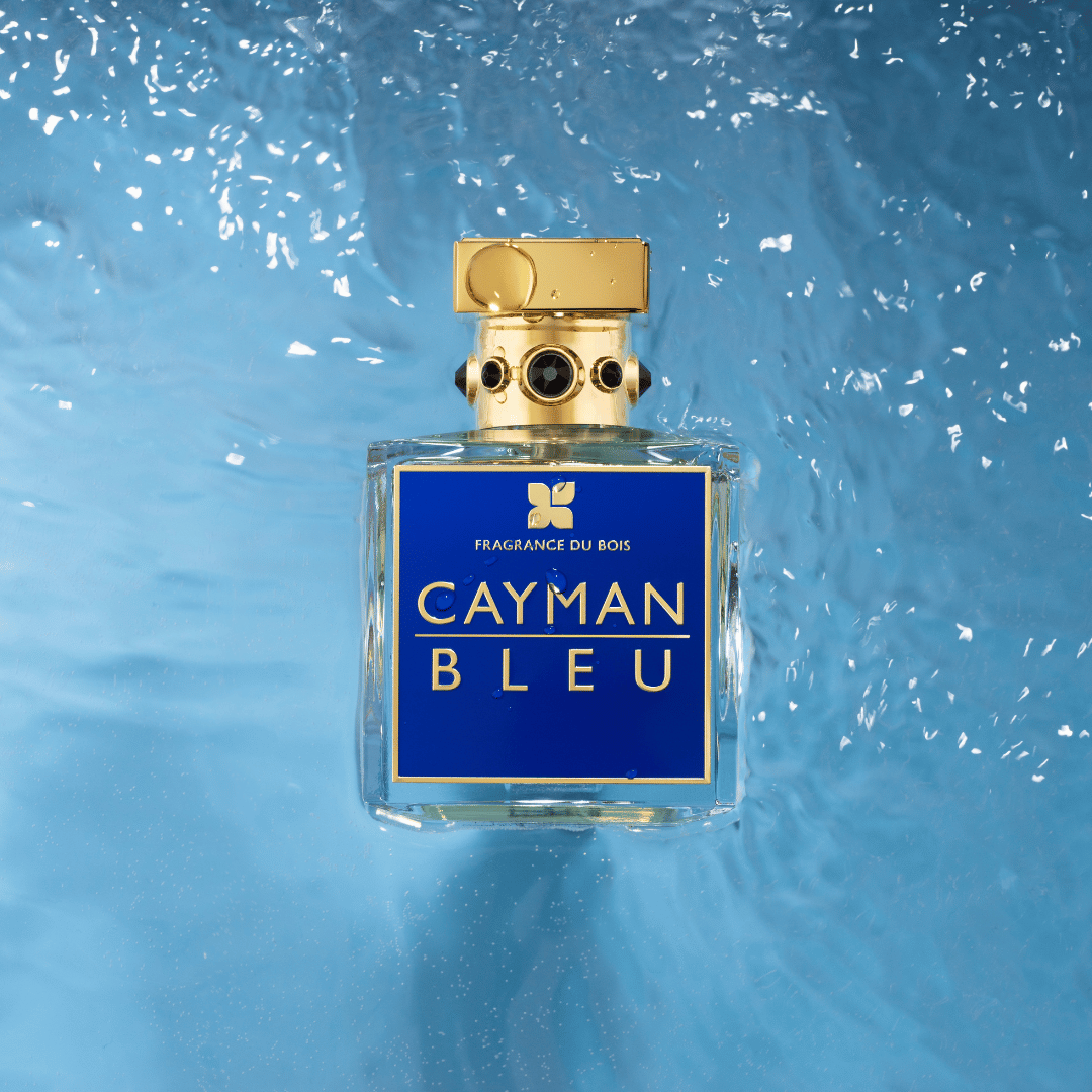 Perfume bottle labeled 'Cayman Bleu' with a blue background