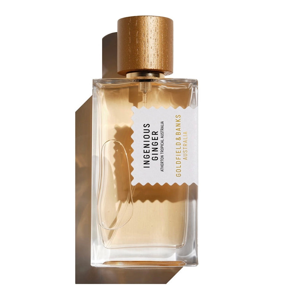 Perfume bottle with gold cap and label on a white background