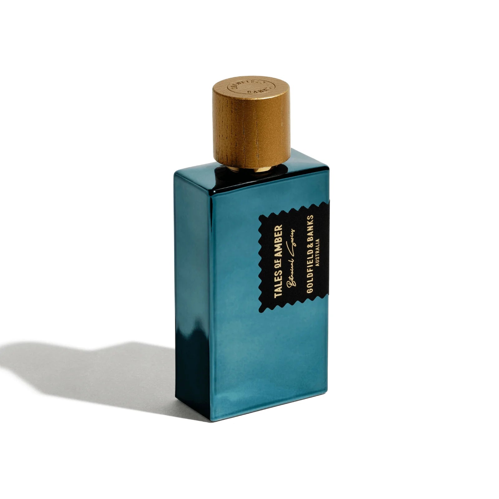 Blue perfume bottle with gold cap on a white background