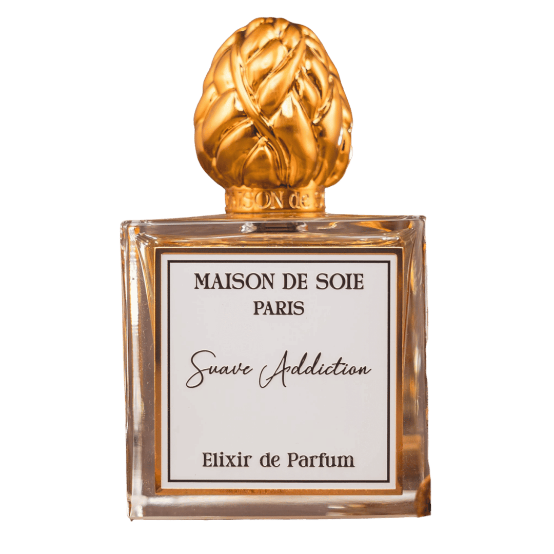 Perfume bottle with gold cap and clear glass body, featuring 'Maison de Soie Paris' on a white background.
