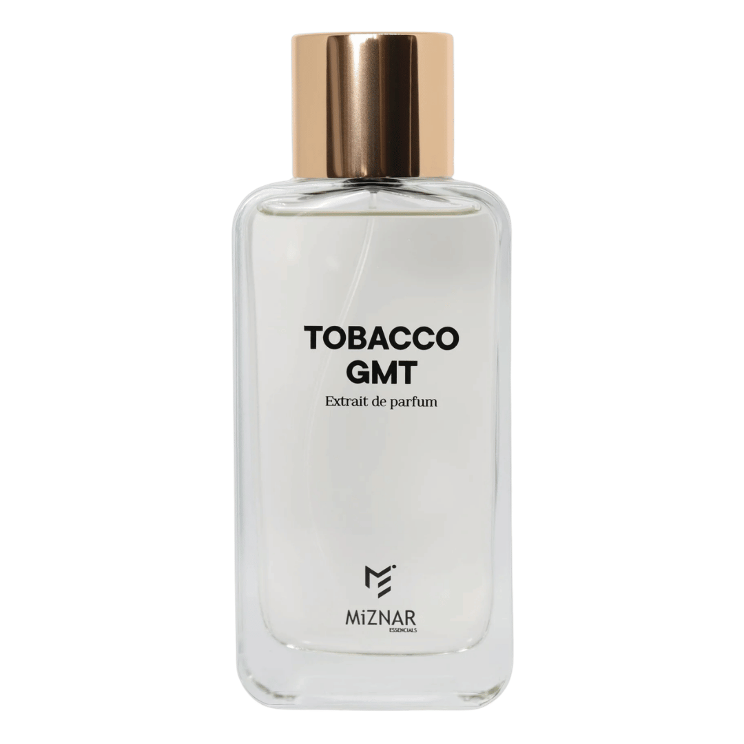 A clear glass perfume bottle labeled 'TOBACCO GMT' with a metallic rose gold cap, set against a solid dark green background. The brand 'MIZNAR' is visible at the bottom of the label.