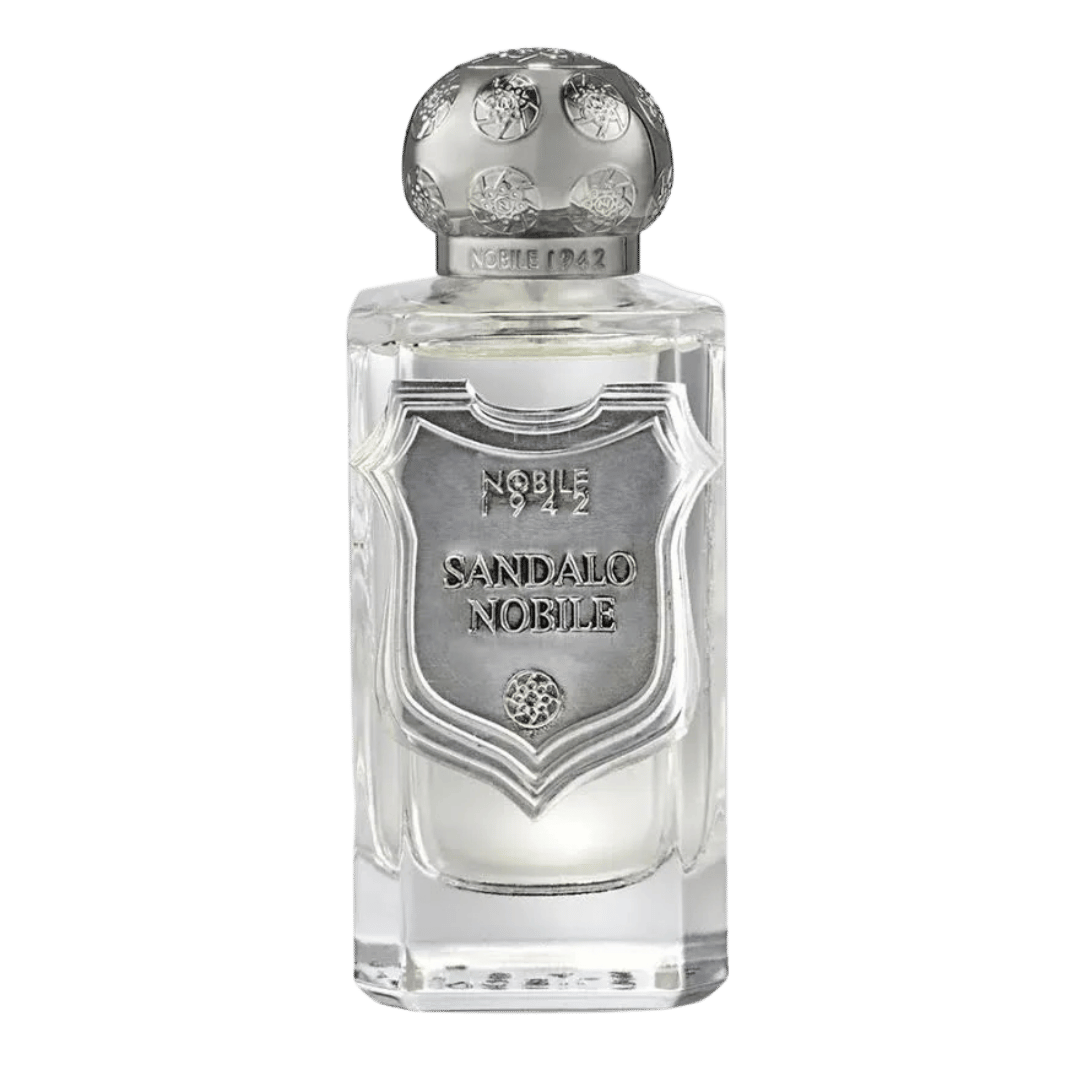 A clear glass perfume bottle with a prominent silver-toned metal crest label and matching silver-toned cap, labeled 'NOBLE 1942 SANDALO NOBILE'.