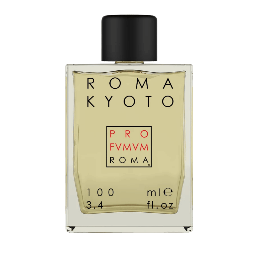 A rectangular glass perfume bottle with a black cap, featuring a pale yellow liquid and a cream-colored label with black and red text. The brand name 'ROMA KYOTO' is prominently displayed at the top of the label.