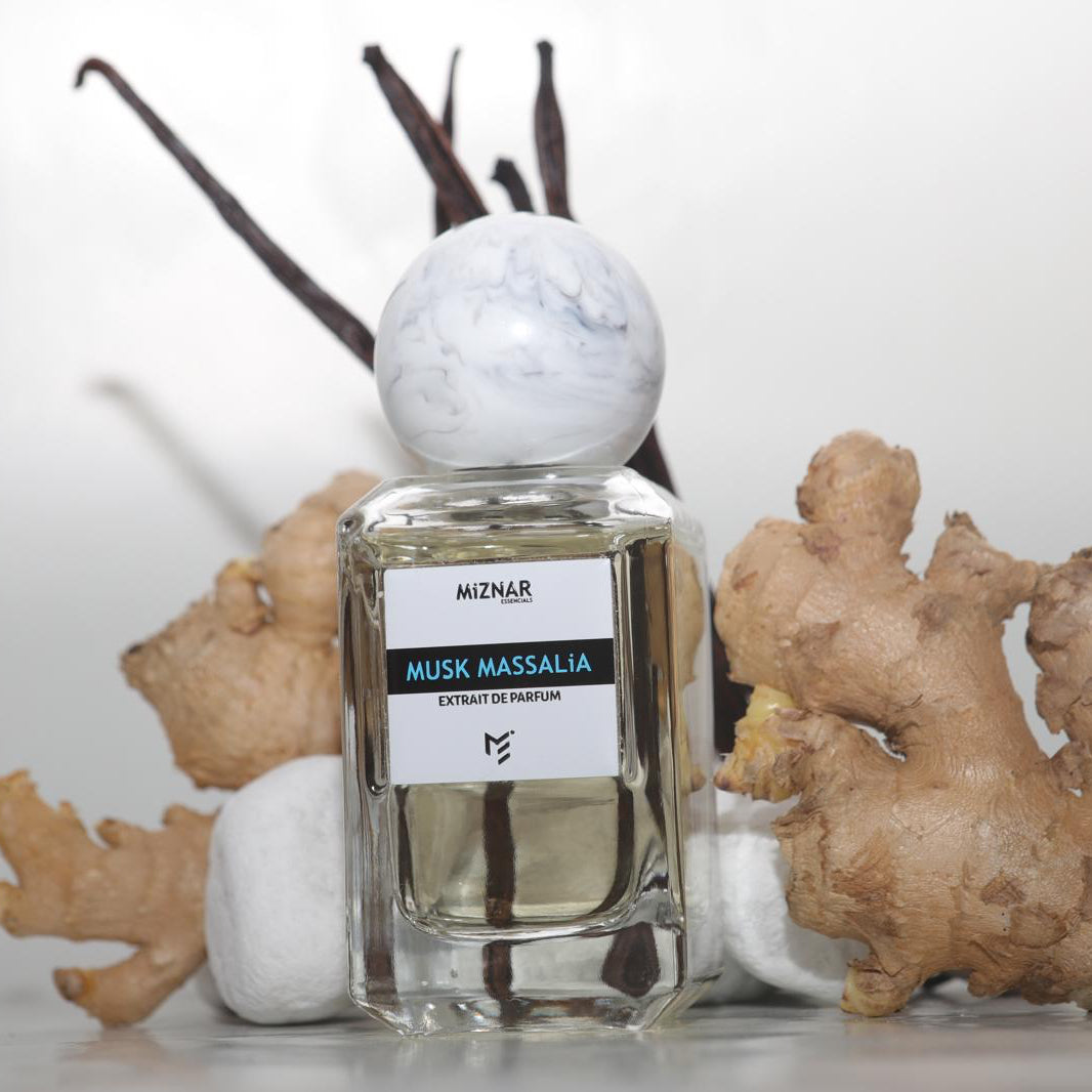Perfume bottle labeled 'Musk Massalia' with ginger root and decorative elements on a light background