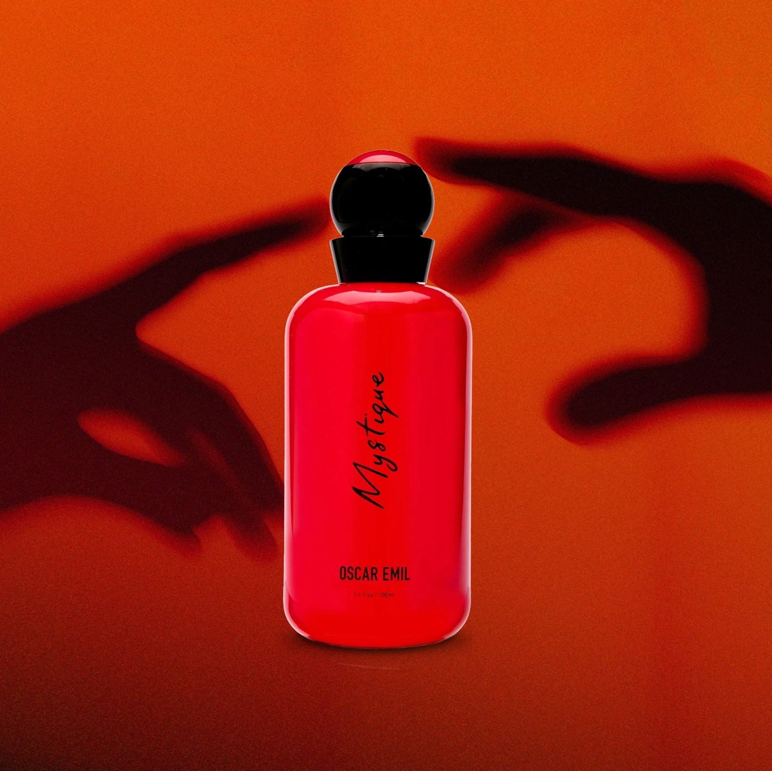 Red bottle labeled 'Mystique' by 'Oscar Emil' on an orange background