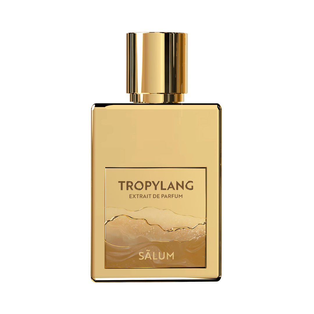 Gold Tropylang perfume bottle on a green background
