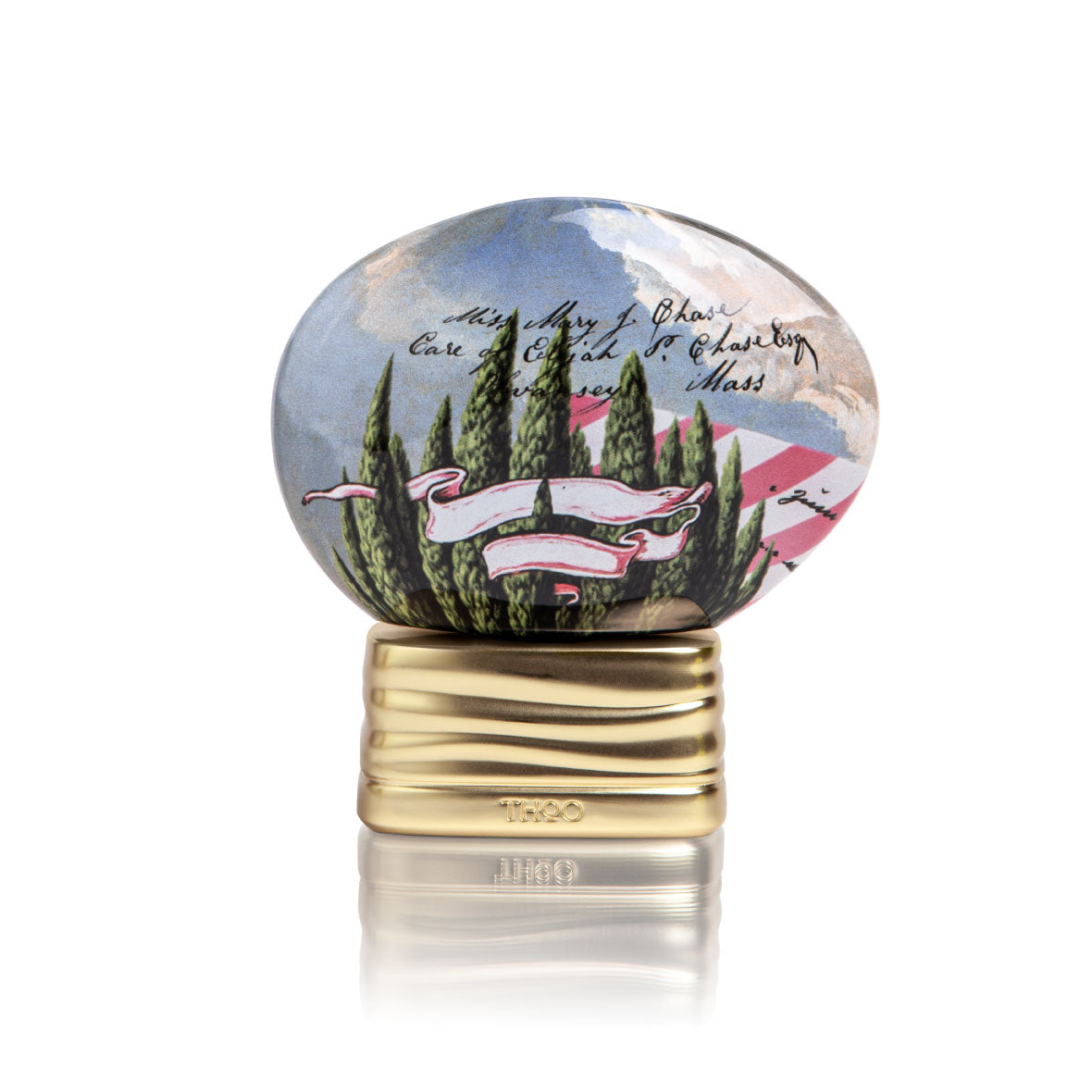 Decorative paperweight with scenic design and gold base on a white background