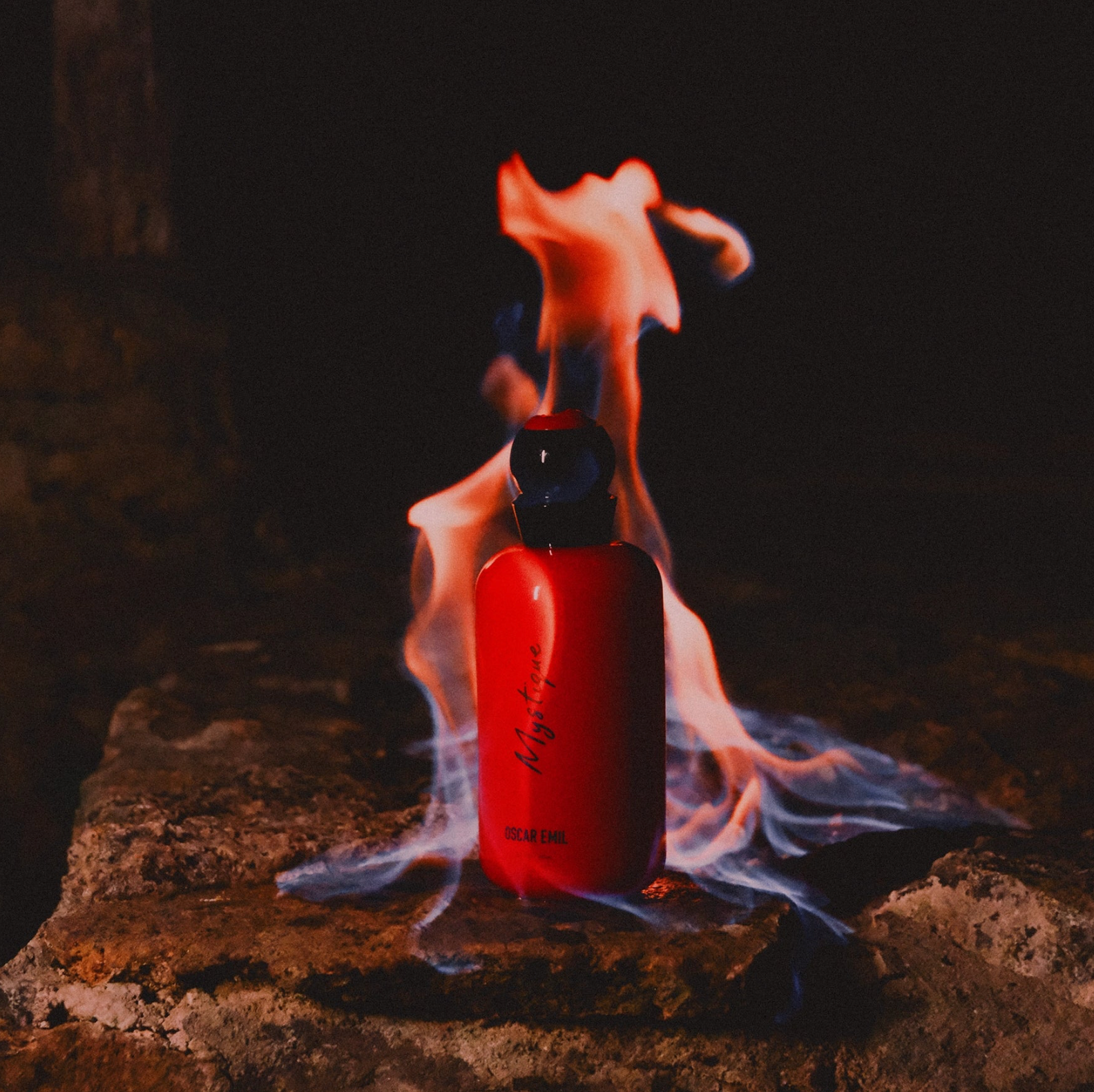 Red bottle with flame on a dark background